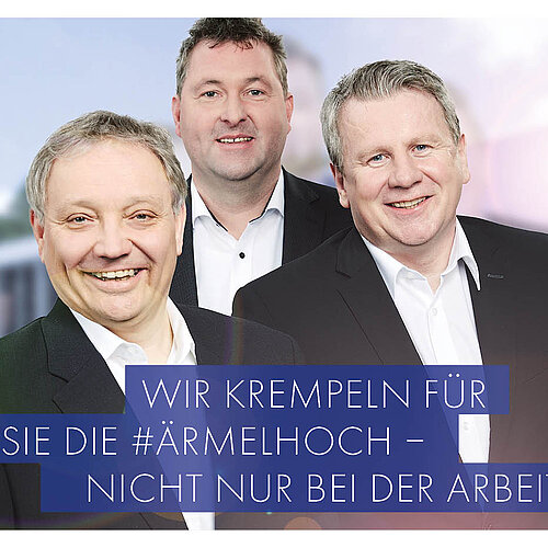 3 Männer im Anzug vor dem GEBRO HERWIG-Firmengebäude - Bildbeschriftung: wir krempeln für Sie die Ärmel hoch - nicht nur bei der Arbeit